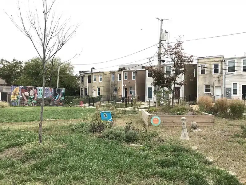 Community garden with mural and houses