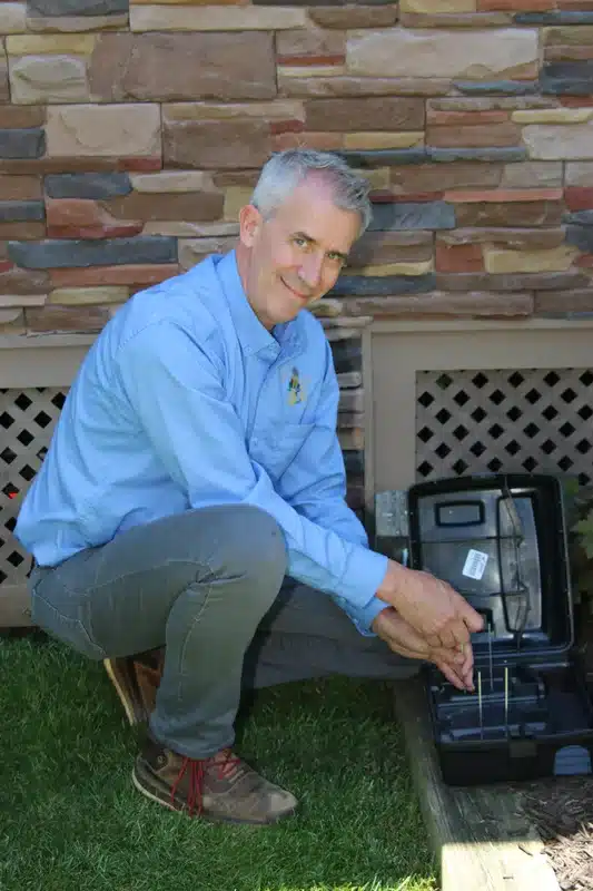 Pest control expert inspecting monitoring station